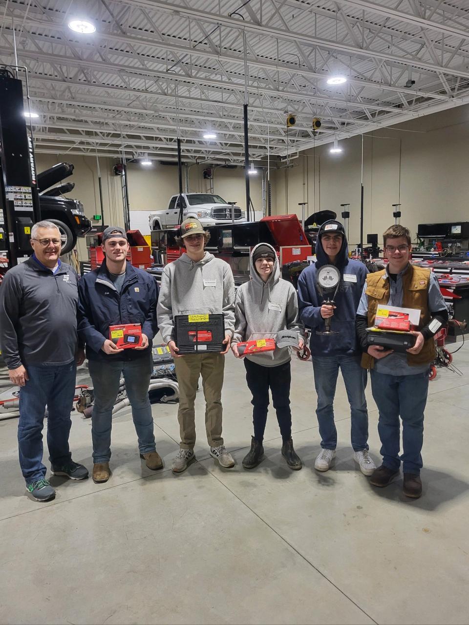(From left) Snap-On Industrial representative Todd Herblet and Petoskey High School seniors JD Cantrell, Joe Berakovich, Brett Kloss, Connor Rice and Chase Goldenstein pose after the Automotive Showdown at Kirtland Community College on Feb. 16, 2024.