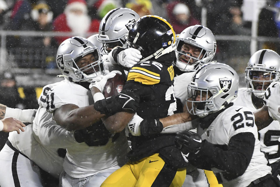 Pittsburgh Steelers running back Najee Harris (22) is gang tackled during the first half of an NFL football game against the Las Vegas Raiders in Pittsburgh, Saturday, Dec. 24, 2022. (AP Photo/Fred Vuich)
