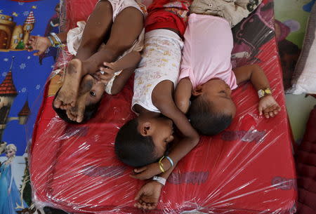 Young Rohingya migrants, who arrived recently by boat, rest at a temporary shelter in Kuala Langsa, in Indonesia's Aceh Province May 25, 2015. REUTERS/Nyimas Laula