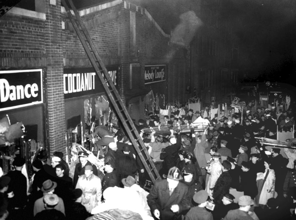 FILE - In this Nov. 28, 1942 file photo, workers help remove victims from the Cocoanut Grove nightclub in Boston, where 492 people died in a fire. A 2019 documentary film, "Six Locked Doors: The Legacy of Cocoanut Grove," tells the story of the disaster that led to an overhaul and stricter enforcement of building safety codes. (AP Photo, File)