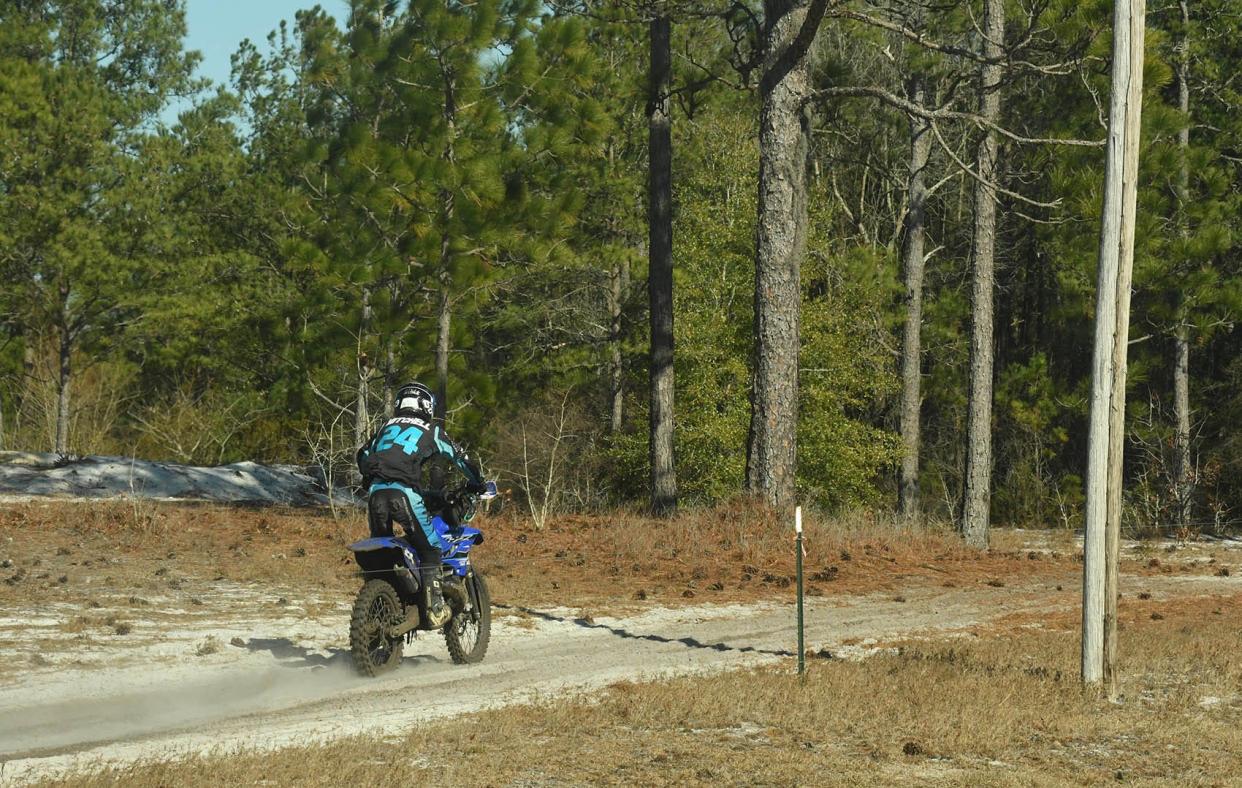 Dirt bikes travel along 532 Carl Meeks Road in Rocky Point. The track is part of an Airbnb.