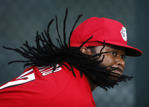 Cincinnati Reds&#39; Johnny Cueto&#39;s hair bounces around as he throws during a spring training baseball workout Monday, Feb. 23, 2015, in Goodyear, Ariz. (AP Photo/John Locher)