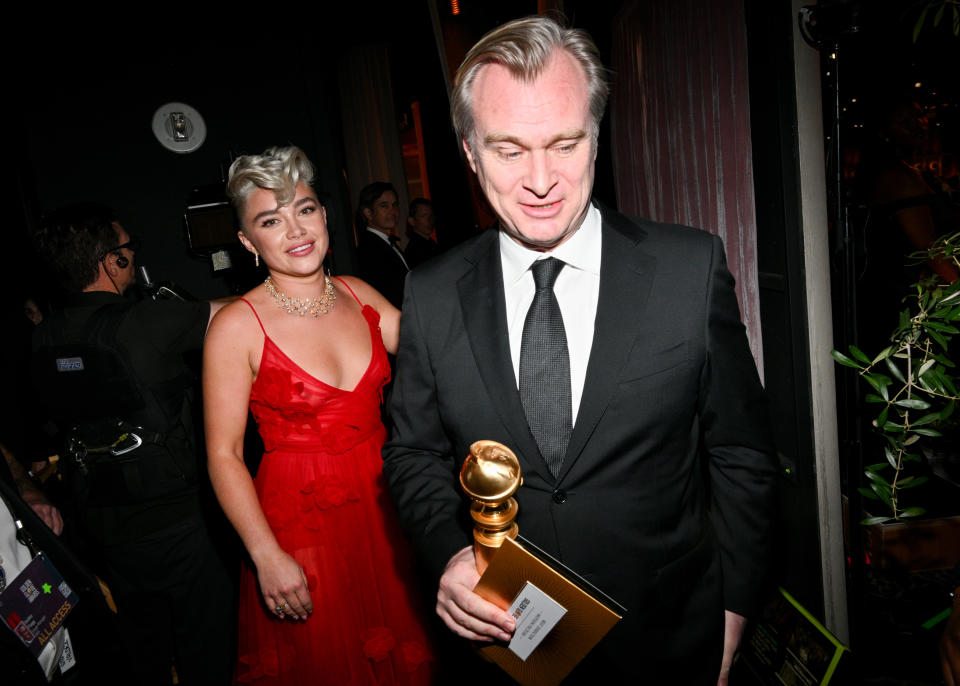 Close-up of Florence and Christopher, who's holding a Golden Globe award