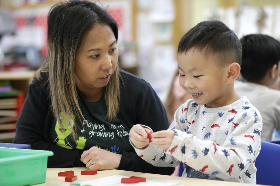 Hmong interpretor Suzie Herr helps Emmett Xiong with a fine motor activity during his 4K class at Foster Elementary School Tuesday, May 2, 2023, in Appleton, Wis. 
Dan Powers/USA TODAY NETWORK-Wisconsin.