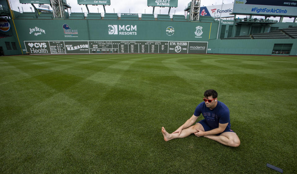 A person stretching on the ground barefoot