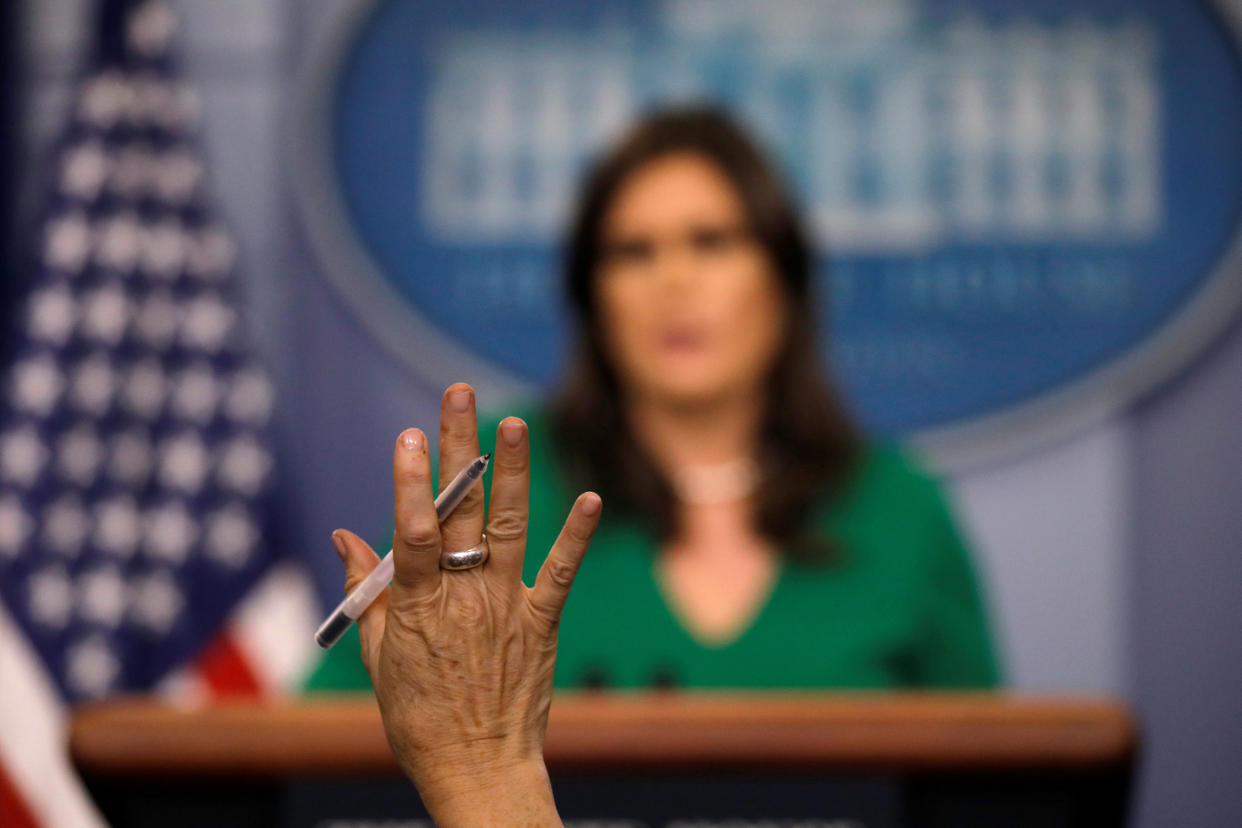 A reporter raises her hand as White House press secretary Sarah Sanders holds the daily briefing at the White House. (Photo: Carlos Barria/Reuters)