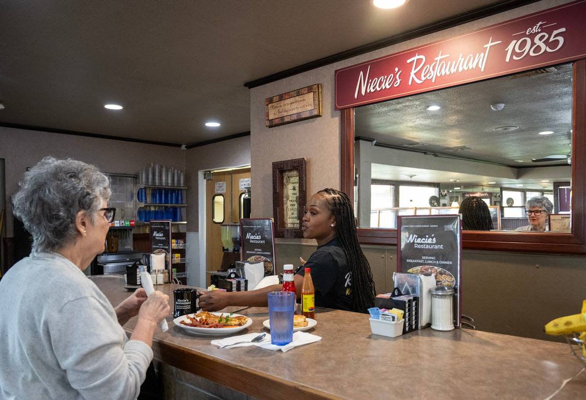 Server Twanee Robinzine refills a coffee for a diner at Niecie’s Restaurant, which, as the sign says, has been around since 1985. Tammy Ljungblad/Tljungblad@kcstar.com