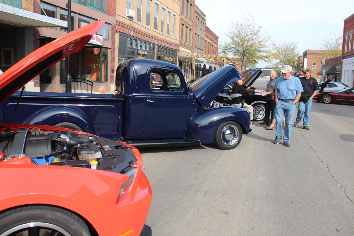 Area residents check out the vehicles lining 2nd Street during the PerryDice Cruizers Car Show on Saturday, Oct. 9, 2021, in Perry.
