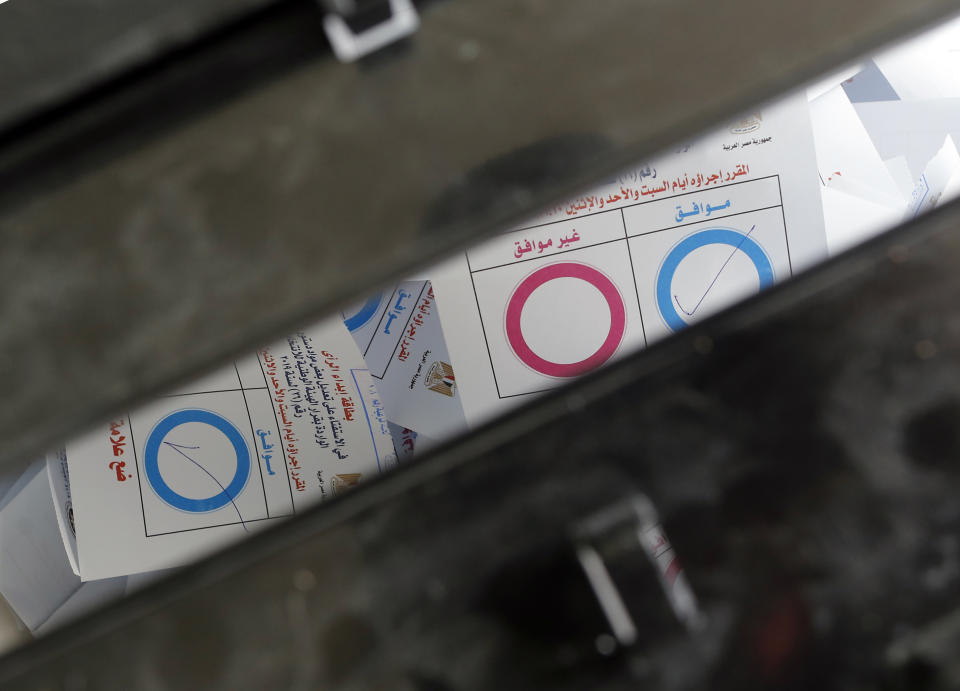 Ballots on constitutional amendments inside a ballot box on the second day of the three-day voting at a polling station in Cairo, Egypt, Sunday, April 21, 2019. Egyptians are voting on constitutional amendments that would allow el-Sissi to stay in power until 2030. Arabic reads, "Agree, in blue, disagree in red". (AP Photo/Amr Nabil)