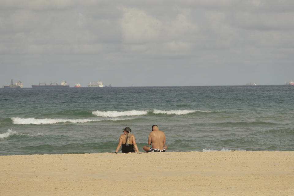 A couple sits on the beach in the town of Ashkelon, Israel, Friday, May 21, 2021, aafter a cease-fire took effect between Hamas and Israel. The 11-day war between Israel and Hamas left more than 200 dead — the vast majority Palestinians — and brought widespread devastation to the already impoverished Hamas-ruled Gaza Strip. (AP Photo/Maya Alerruzzo)