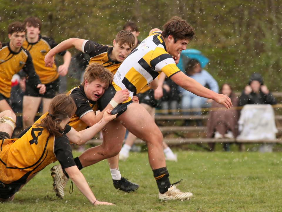 Ralph Merz advances the ball for Warrior Rugby during a 69-7 victory against Perrysburg on Sunday.