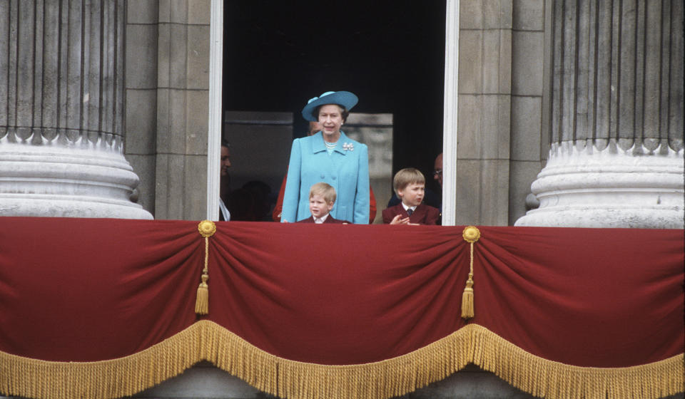 Queen Elizabeth II with the young Prince William and Prince Harry on the balcony of Buckingham Palace after the annual Trooping of the Colour ceremony in June, 1988.