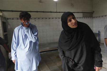 Saeeda Sarbazi, sister of Abdul Razzaq Baloch, reacts as she identifies his corpse at the Edhi Foundation office in Karachi August 21, 2013. REUTERS/Stringer