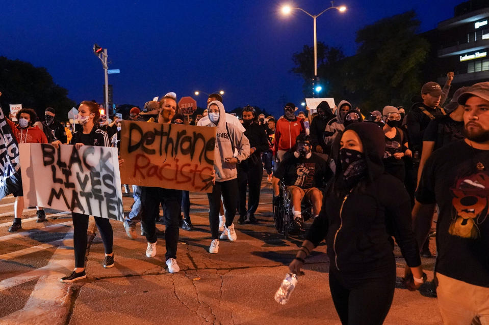 FILE - In this Oct. 9, 2020 file photo, protesters gather on the street, in Wauwatosa, Wis., after District Attorney John Chisholm refused to issue charges against Wauwatosa Police Officer Joseph Mensah for the Feb. 2, 2020, fatal shooting of 17-year-old Alvin Cole at Mayfair Mall. Waukesha County Sheriff Eric Severson said Tuesday, Jan. 26, 2021, that he hired Joseph Mensah after an extensive review that found his use of force was proper in three shootings. (AP Photo/Morry Gash File)