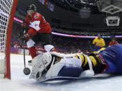 Canada's Sidney Crosby (L) scores on a breakaway past Sweden's goalie Henrik Lundqvist during the second period of their men's ice hockey gold medal game at the Sochi 2014 Winter Olympic Games February 23, 2014. REUTERS/Julio Cortez/Pool