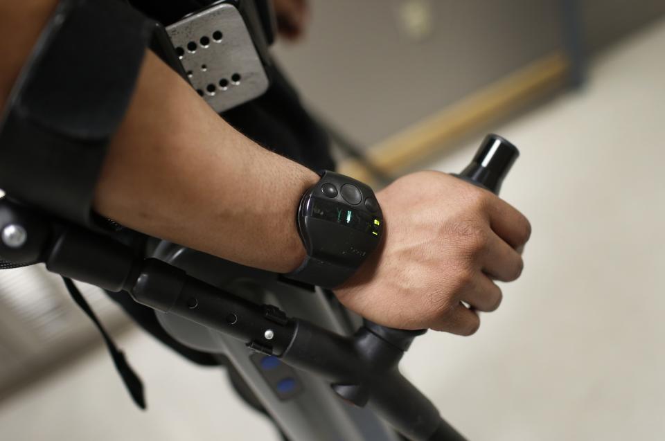 Samuels engages ReWalk electric powered exoskeletal suit with a wireless wrist band controller on his wrist during a therapy session at the Mount Sinai Medical Center in New York City