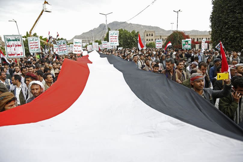 Houthi supporters chant slogans holding signs reading "Death to America, Death to Israel", as they attend a rally in Sanaa, March 2023