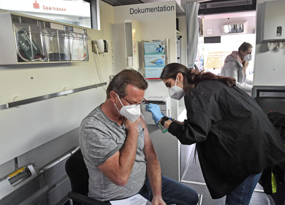 Harald Fischer gets a Moderna vaccination in a vaccination mobile on a square at the district Chorweiler in Cologne, Germany, Monday, May 3, 2021. The city of Cologne started a program to bring COVID-19 vaccination to people living in this neighborhood with a high corona incidence. (AP Photo/Martin Meissner)