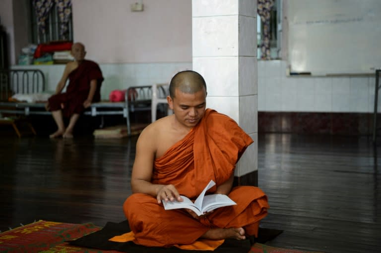 Ottama, a prominent monk in Buddhist nationalist circles, reads a book at the temple in Yangon