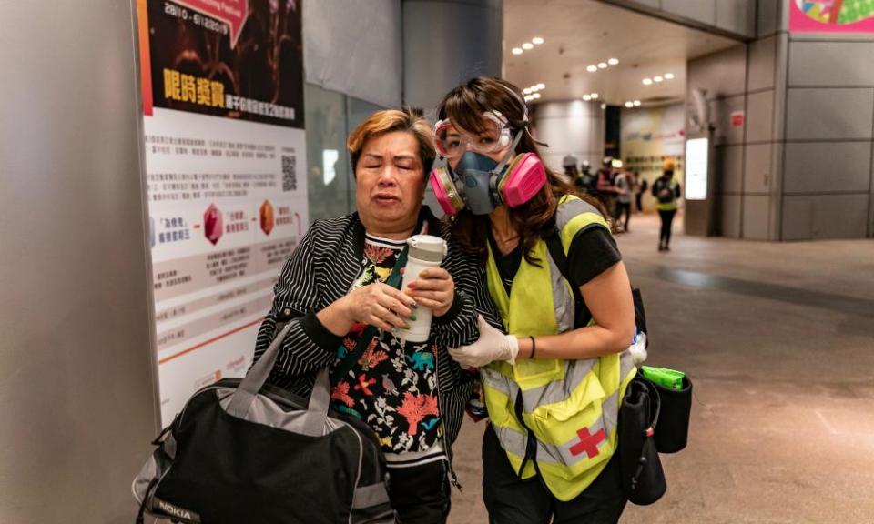 A woman is assisted by a volunteer medic after police fired teargas on 10 November.