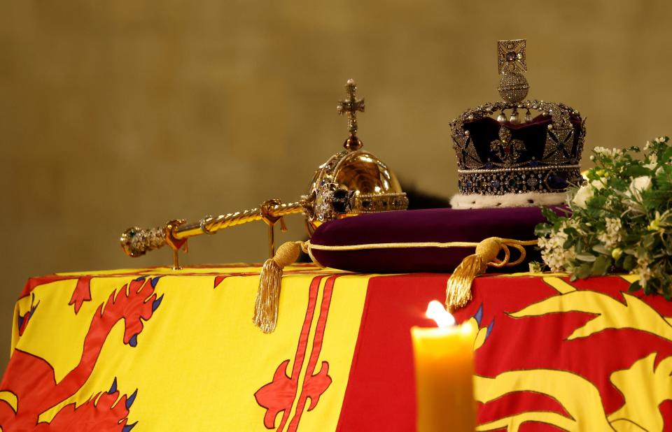 The coffin of Queen Elizabeth II, draped in the Royal Standard with the Imperial State Crown and the Sovereign's orb and sceptre, lies in state on the catafalque in Westminster Hall, at the Palace of Westminster, London, ahead of her funeral on Monday. Picture date: Thursday September 15, 2022.