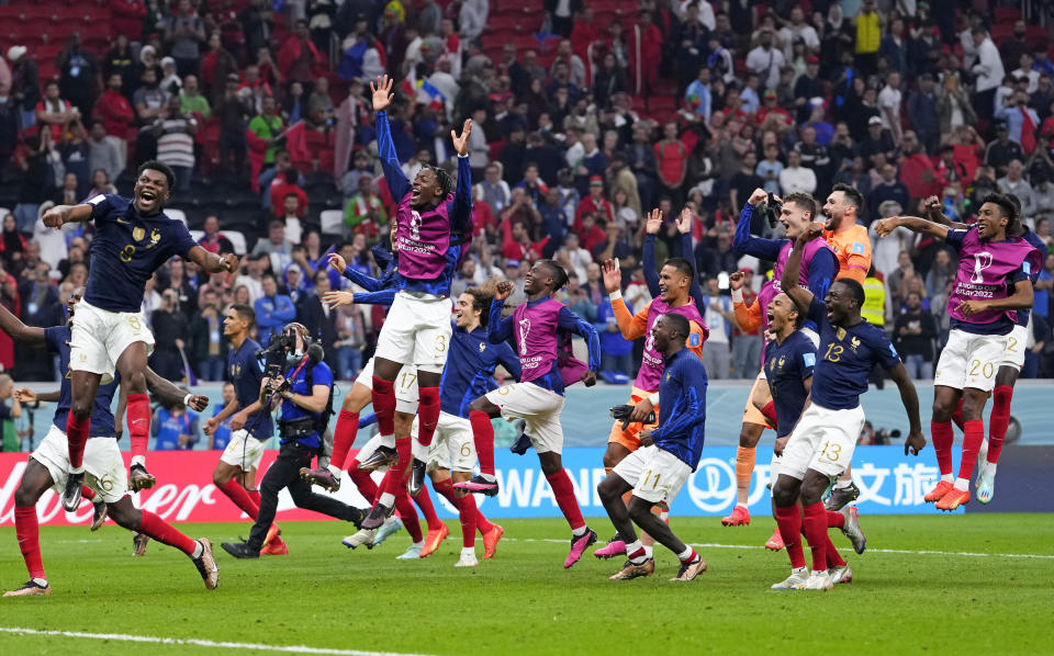 France players celebrate at the end of the World Cup semifinal soccer match between France and Morocco at the Al Bayt Stadium in Al Khor, Qatar, Wednesday, Dec. 14, 2022. France won 2-0 and will play Argentina in Sunday's final. (AP Photo/Manu Fernandez)