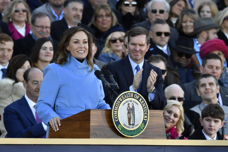 Kentucky Lt. Governor Jacqueline Coleman, left, is applauded by Ky. Governor Andy Beshear as she speaks to the audience gathered to witness her public swearing in ceremony on the steps of the Kentucky State Capitol in Frankfort, Ky., Tuesday, Dec. 12, 2023. (AP Photo/Timothy D. Easley)