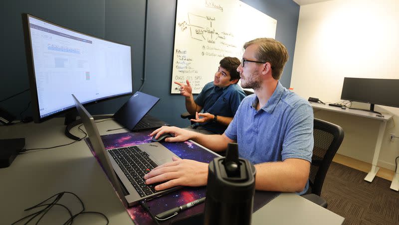 Connor Perkett and Hunter Harmer of EspriGas discuss work while in their office at Work Hive in Salt Lake City on Tuesday, Aug. 1, 2023.