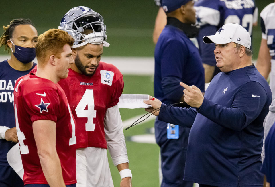 Dallas Cowboys head coach Mike McCarthy talks to Andy Dalton and Dak Prescott.