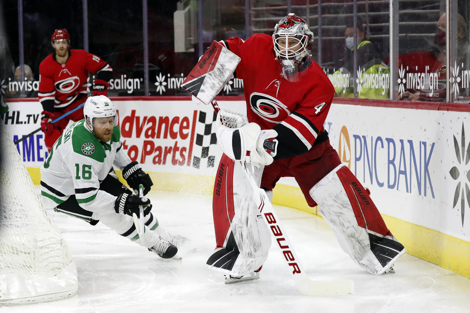 Carolina Hurricanes goaltender James Reimer (47) clears the puck from a charging Dallas Stars' Joe Pavelski (16) during the first period of an NHL hockey game in Raleigh, N.C., Sunday, Jan. 31, 2021. (AP Photo/Karl B DeBlaker)