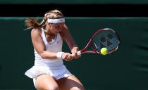 Germany's Sabine Lisicki in action against France's Marion Bartoli during day twelve of the Wimbledon Championships at The All England Lawn Tennis and Croquet Club, Wimbledon.