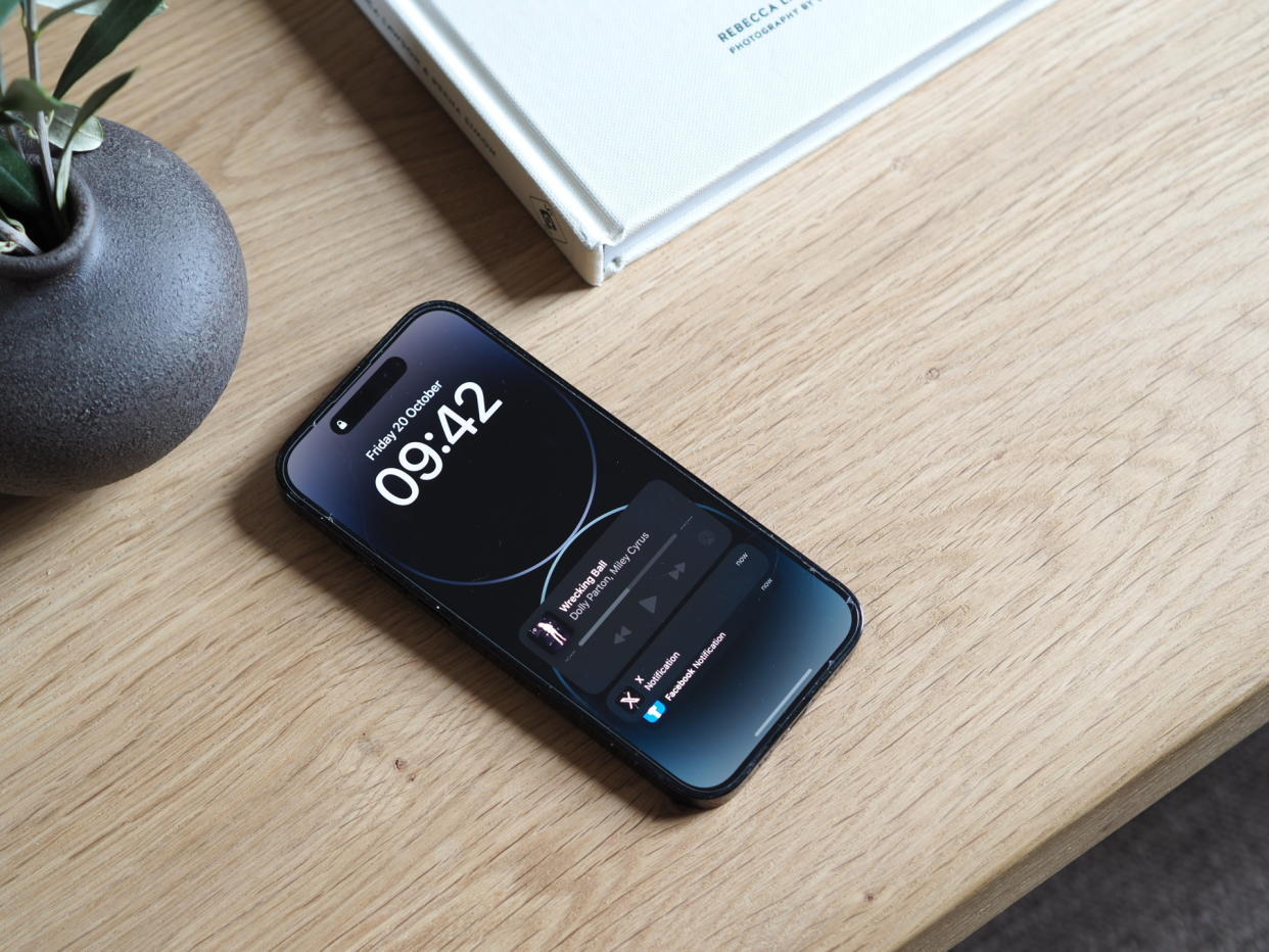  An iphone on a coffee table. 