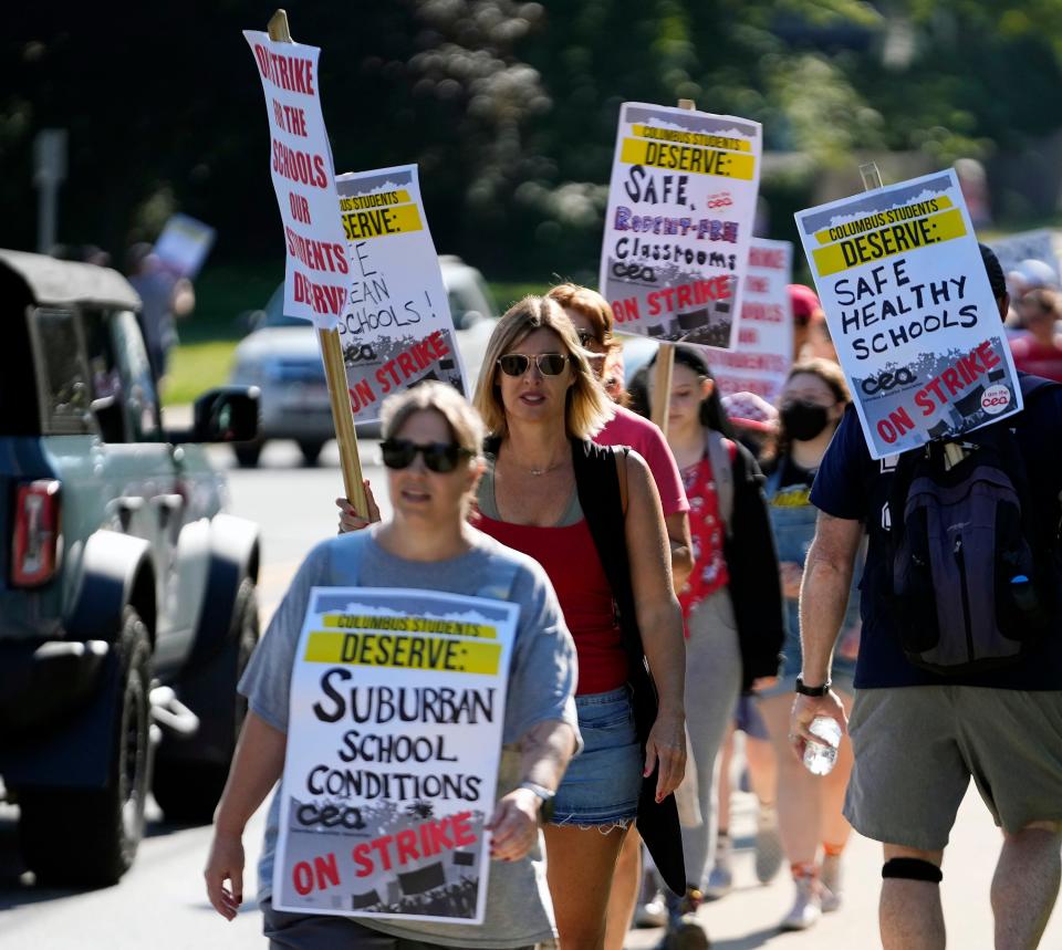 Teachers, parents and students walk the picket line during the Columbus Education Association strike at Whetstone High School in Columbus on Wednesday.