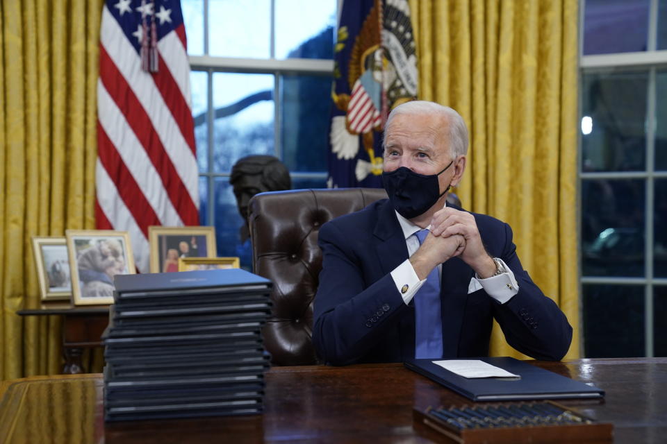 FILE - In this Jan. 20, 2021, file photo President Joe Biden waits to sign his first executive order in the Oval Office of the White House in Washington. Immigrant rights activists energized by a new Democratic administration and majorities on Capitol Hill are gearing up for a fresh political battle to push through a proposed bill from Biden that would open a pathway to citizenship for up to 11 million people. (AP Photo/Evan Vucci, File)