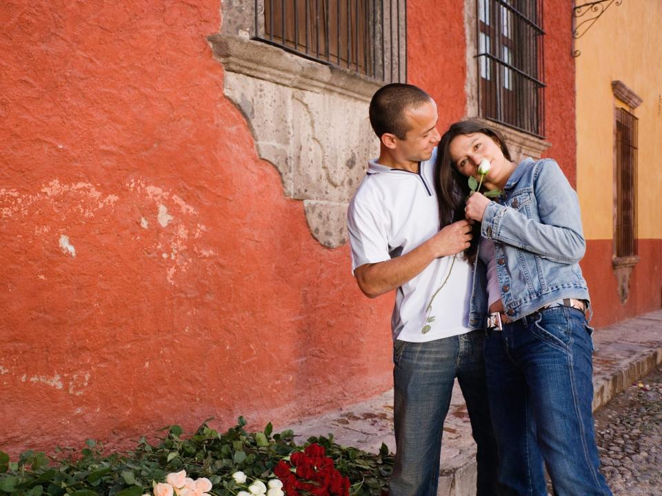 young couple smelling flower