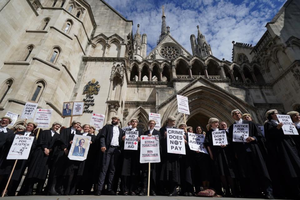 Barristers gather outside the Royal Courts of Justice in London (Kirsty O’Connor/PA) (PA Wire)