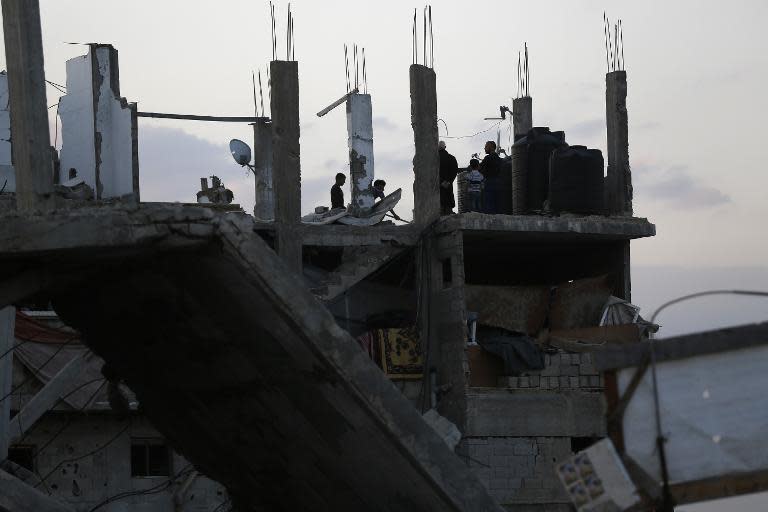 Palestinians work on the rubble of their house that was destroyed during the 50-day war between Israel and Hamas militants in 2014, in Gaza City's al-Shejaiya neighbourhood, on March 31, 2015