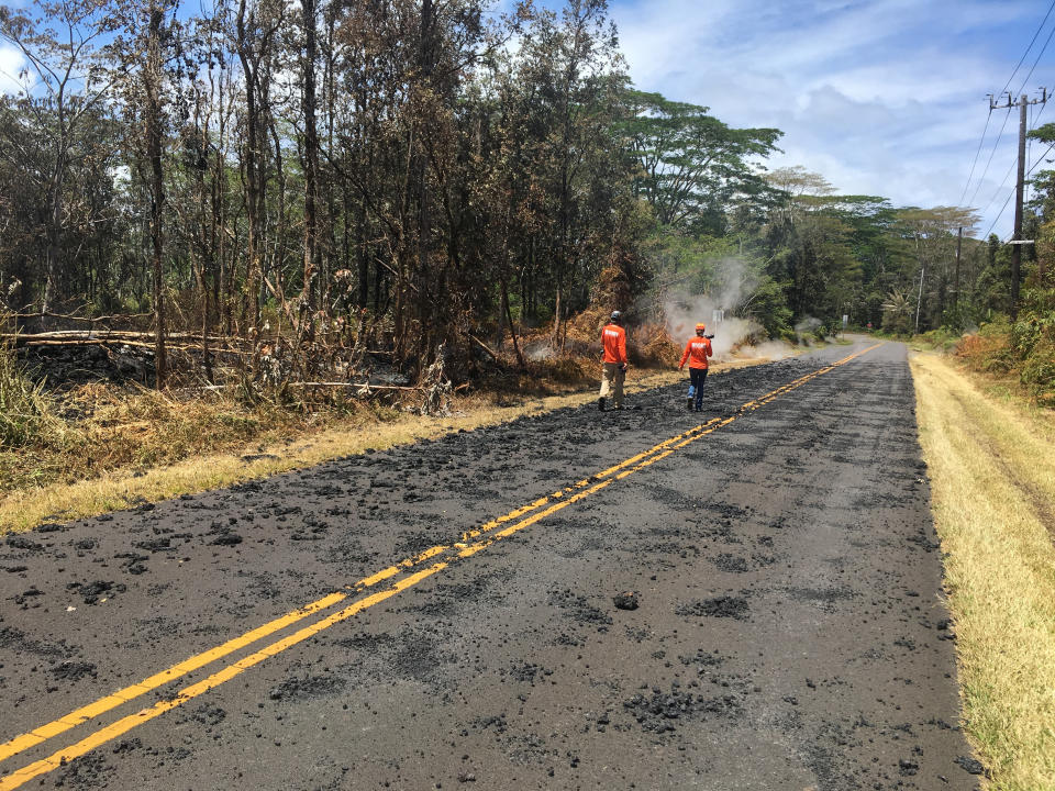 U.S. Geological Survey scientists monitor Kilauea's eruption spatter on the roads in Leilani Estates&nbsp;on Sunday.