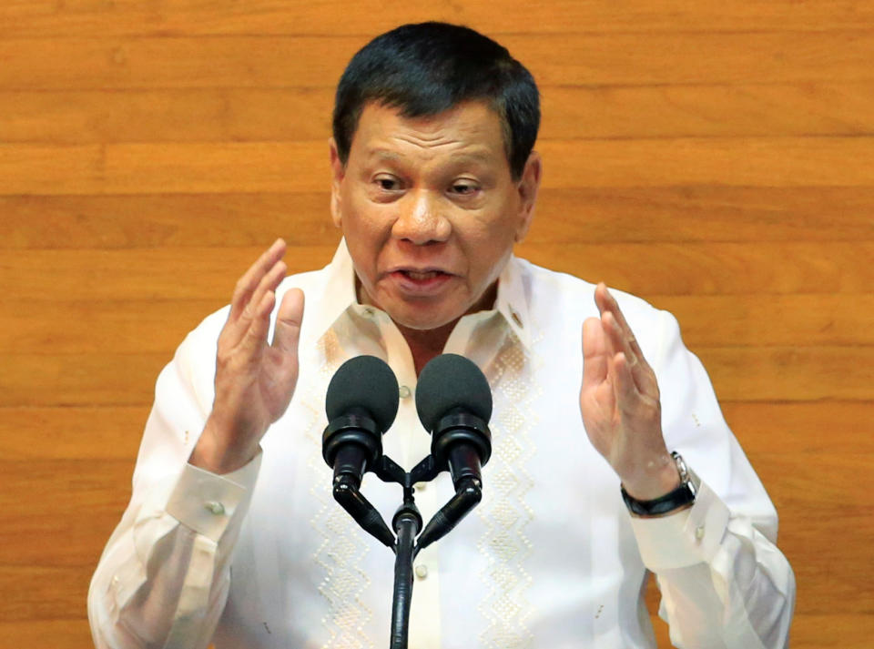 FILE PHOTO: Philippine President Rodrigo Duterte (C) gestures as he delivers a speech during the State of the Nation Address (SONA) on the Joint Session of the 17th Congress at the House of the Representatives in Quezon City, Metro Manila, Philippines July 24, 2017. REUTERS/Romeo Ranoco