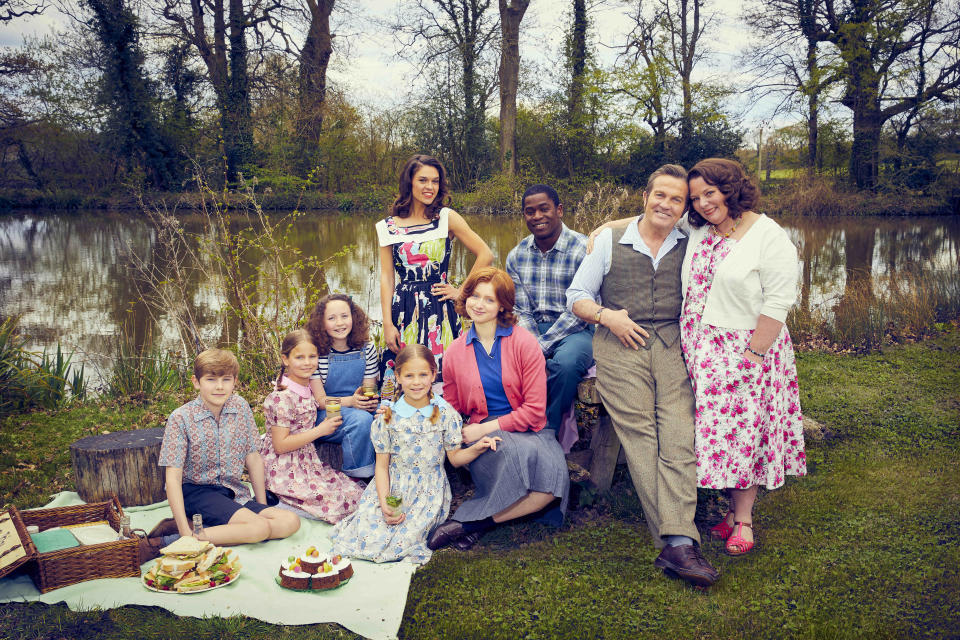 This image and the information contained in it are strictly embargoed until 00:01 Thursday 30 September 2021. From Objective Fiction / Genial Productions. The Larkins on ITV and ITV Hub. Pictured: Montgomery Larkin (Liam Middleton), Petunia Larkin (Rosie Coleman), Victoria Larkin (Lola Shepelev), Zinnia Larkin (Davina Coleman), Mariette (Sabrina Bartlett), Primrose Larkin (Lydia Page), Charley (Tok Stephen), Pop Larkin (Bradley Walsh) and Ma Larkin (Joanna Scanlan). This photograph is (C) ITV Plc / Objective Fiction / Genial Productions and may only be reproduced for editorial use directly in connection with the above programme or event or ITV plc. Once made available by ITV plc Picture Desk, this photograph may only be reproduced once up to the transmission (TX) date and no reproduction fee will be charged. Any subsequent use may incur a charge. This photograph must not be manipulated (other than simple cropping) in a way that alters the appearance of the subject in a way that ITV plc Picture Desk considers harmful or inappropriate. This photograph must not be distributed to any other company, publication or website, nor may it be permanently archived without the express written permission of ITV Picture Desk. Full terms and conditions can be found on www.itv.com/presscentre/itvpictures/terms. For more information please contact: james.hilder@itv.com / 0207 157 3052n