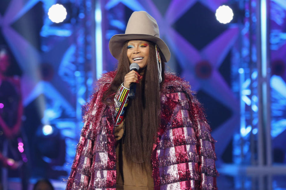 Close-up of Erykah onstage holding a microphone