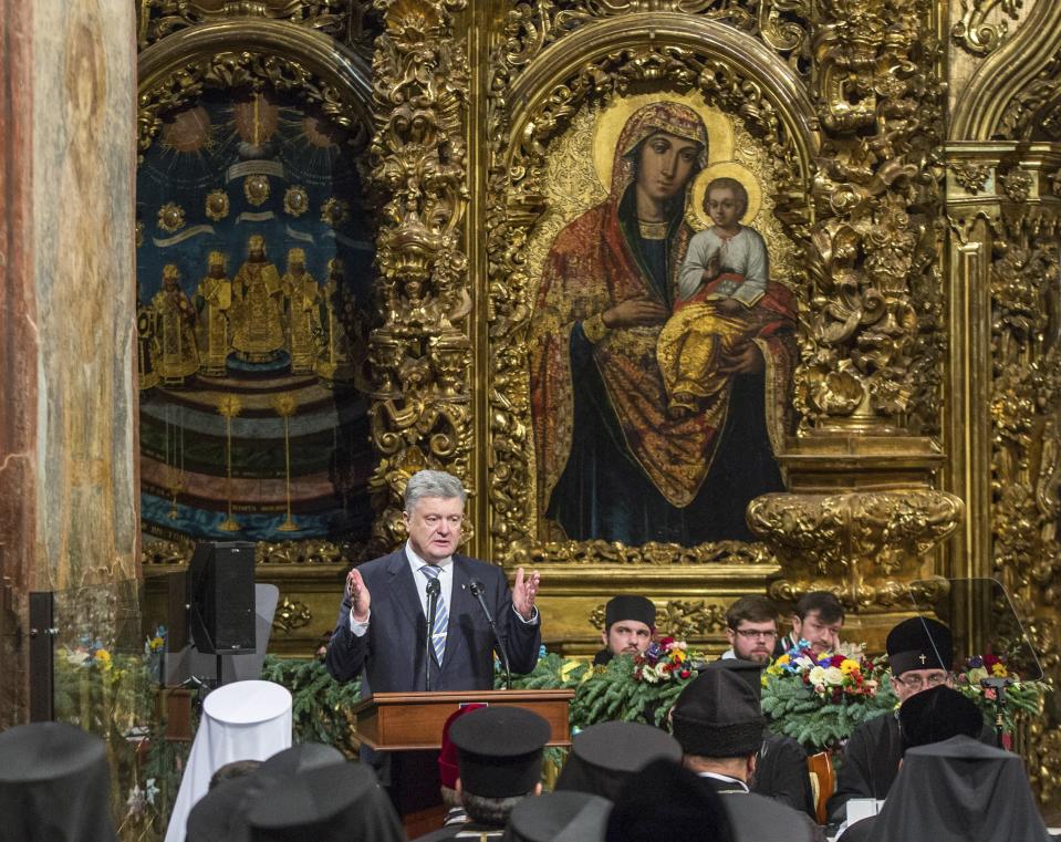 Ukrainian President Petro Poroshenko gestures while speaking at a closed-door synod of three Ukrainian Orthodox churches to approve the charter for a unified church and to elect leadership in the St. Sophia Cathedral in Kiev, Ukraine, Saturday, Dec. 15, 2018. Poroshenko has told the crowd "the creation of our Church is another declaration of Ukraine's independence and you are the main participants of this historic event." (Mykhailo Markiv, Ukrainian Presidential Press Service/Pool Photo via AP)