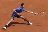 Thomaz Bellucci of Brazil plays a shot to Kei Nishikori of Japan during their men's singles match at the French Open tennis tournament at the Roland Garros stadium in Paris, France, May 27, 2015. REUTERS/Gonzalo Fuentes