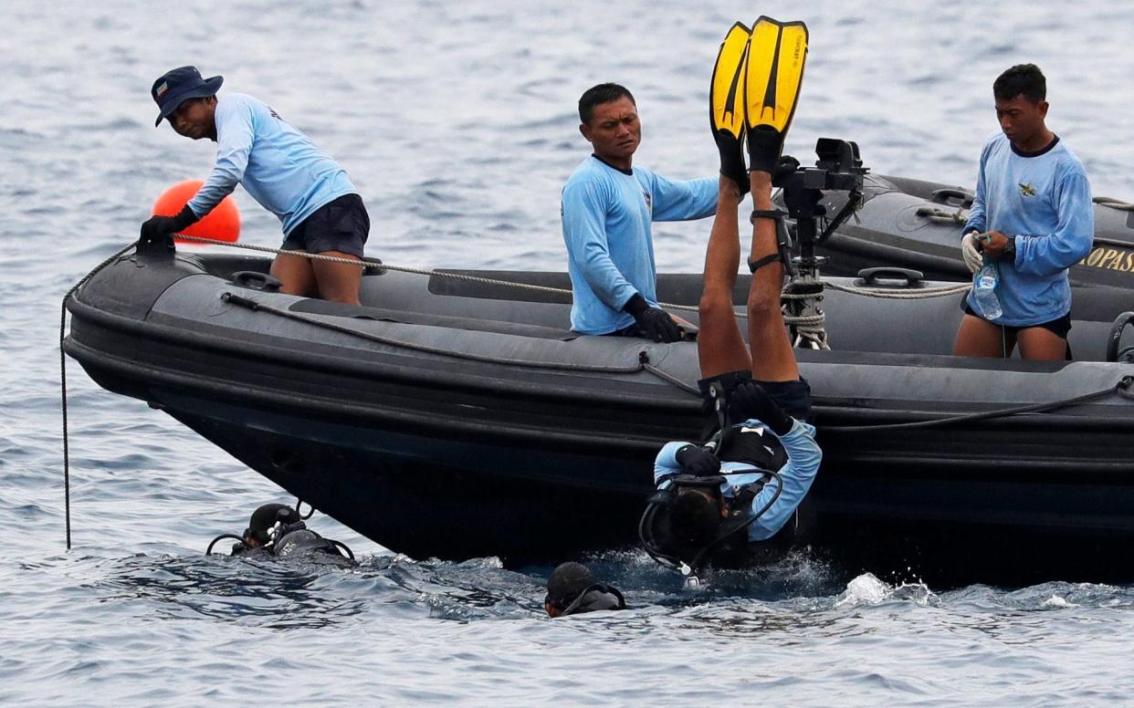 Indonesian navy divers searching waters at the location of the Lion Air flight JT610 crash - REUTERS