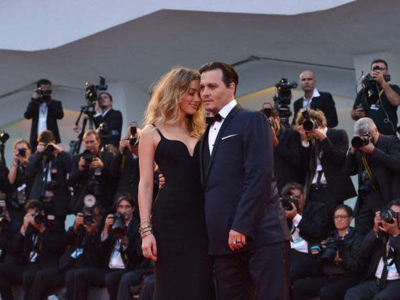 File photo taken in September 2015 of US actor Johnny Depp with ex-wife US actress and model Amber Heard. (Tiziana Fabi/AFP via Getty Images)