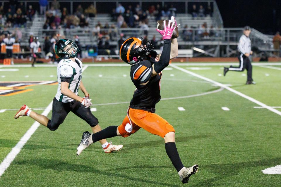 Hanover's Joey Wilkinson (2) completes a 70-yard pass from Hanover's Chase Roberts (3) for a touchdown during the second half of a football game between the Hanover Nighthawks and York Tech Spartans, Saturday, Oct. 29, 2022, at Sheppard-Myers field in Hanover. The Nighthawks won, 35-25.