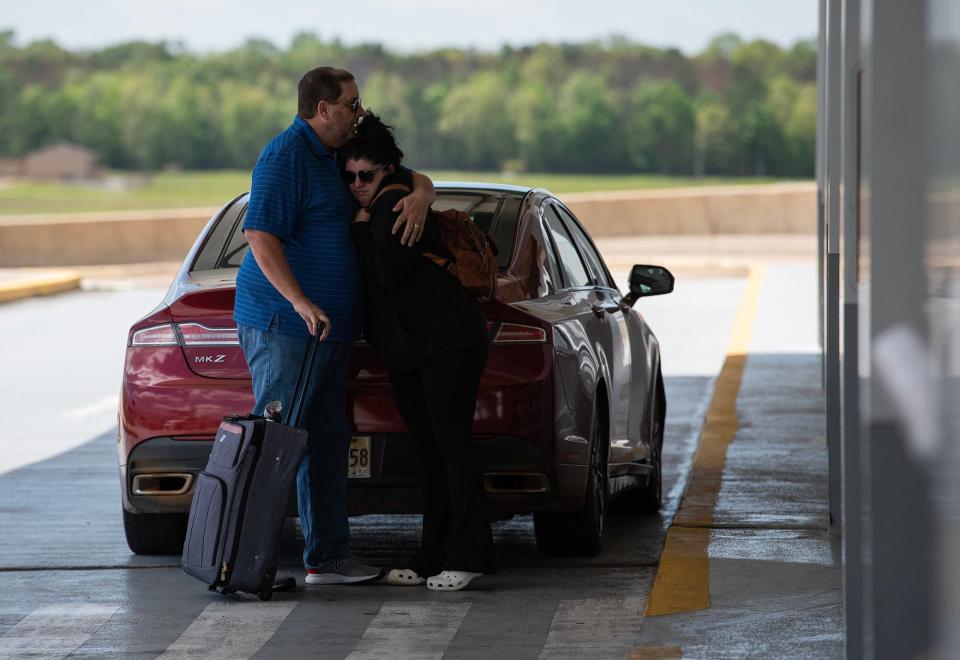 Tyler Scott hugs his daughter, Regan Scott, before she flies home to Virginia at the Jackson-Medgar Wiley Evers International Airport in Jackson on Wednesday.