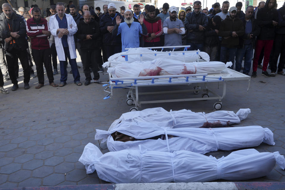 Palestinians mourn their relatives killed in the Israeli bombing of the Gaza Strip in Deir al Balah, Gaza Strip, on Monday, Jan. 8, 2024. (AP Photo/Adel Hana)