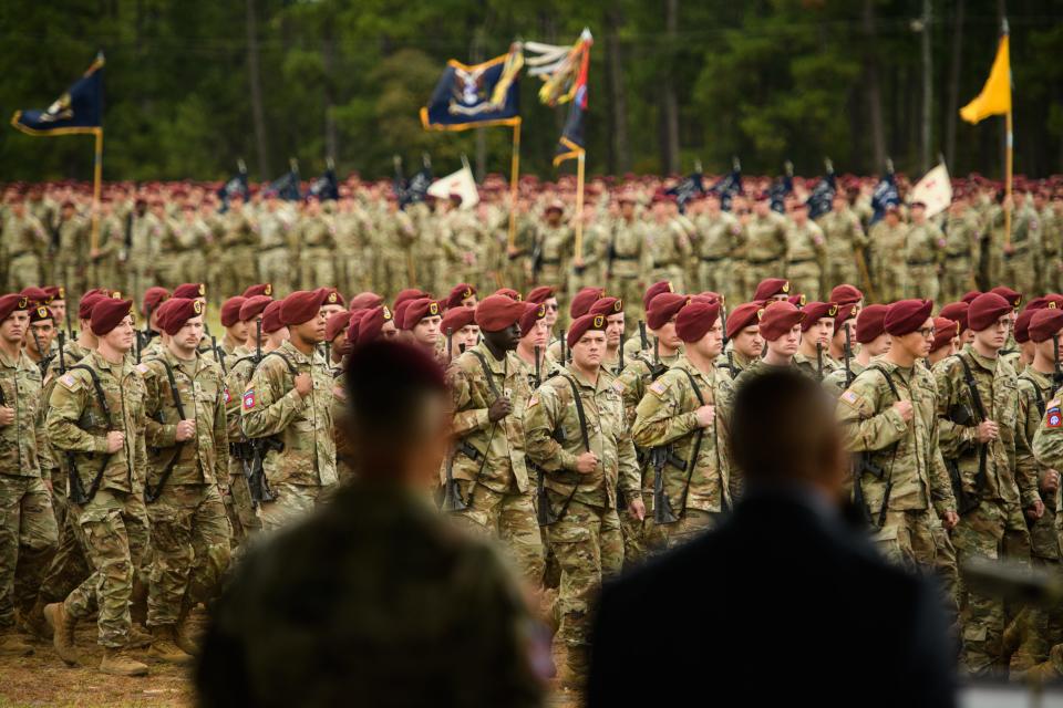 Paratroopers march past Maj. Gen. Christopher LaNeve and retired Command Sgt. Maj. Thomas Capel during the 82nd Airborne Division Review in 2022
