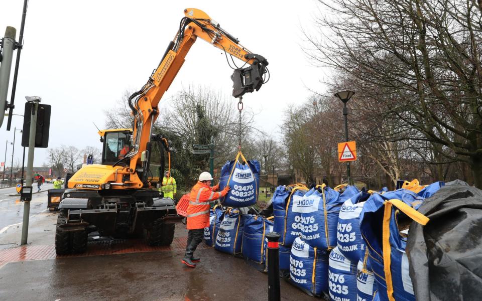 Workmen have been drafted in to prepare flood defences near the River Ouse in Yorkshire - Danny Lawson/PA